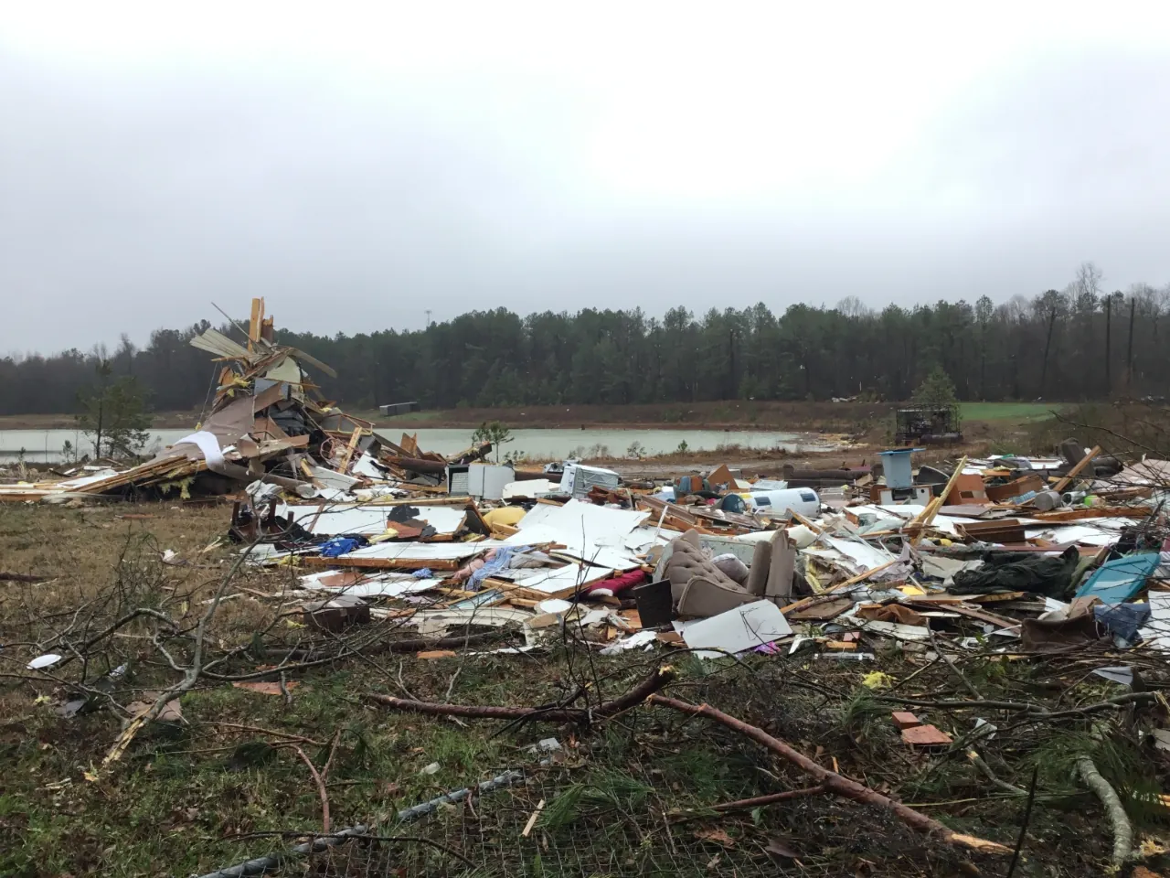 Roof and wall damage to a single-storey house after a tornado